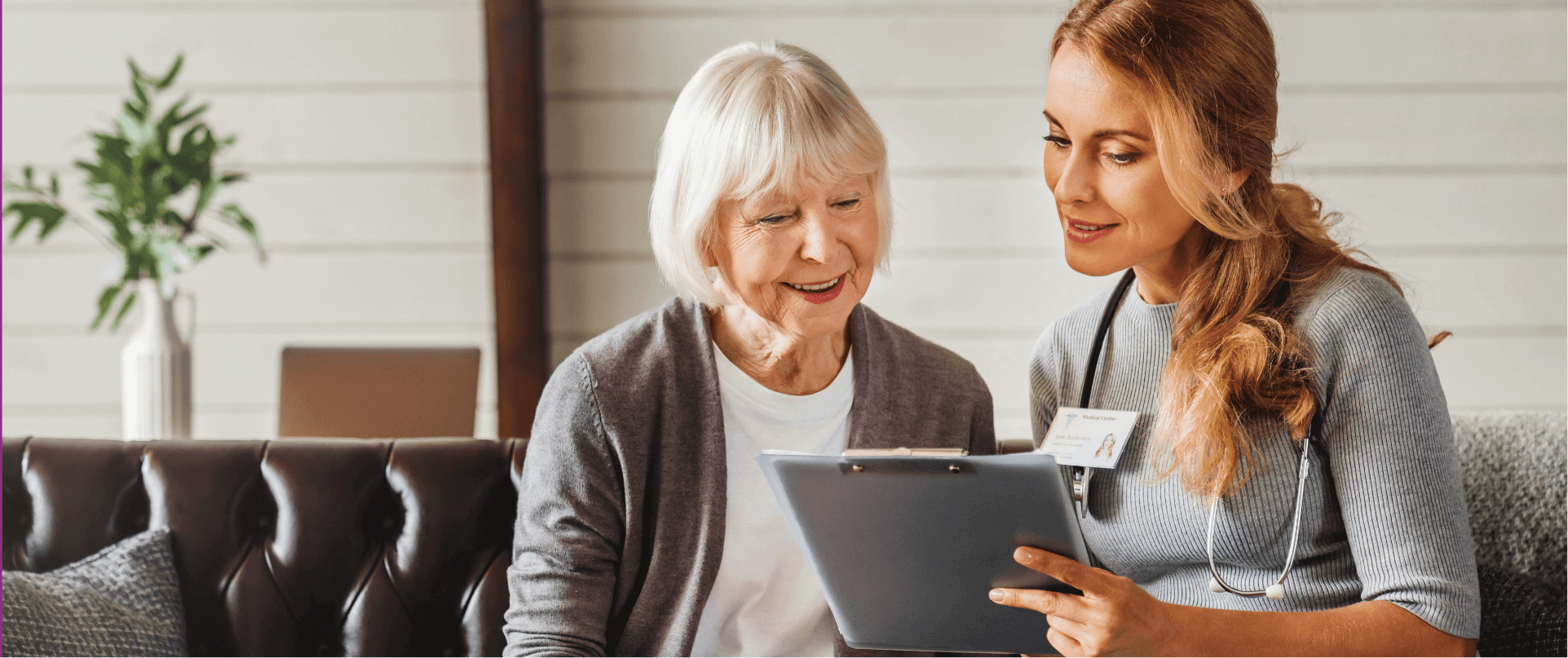 Female doctor and elder woman reading a document together