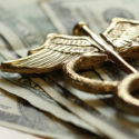 Medical symbol over US dollars